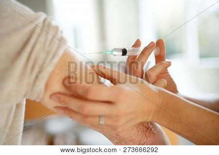 Close up of senior woman geting flu shot                              
