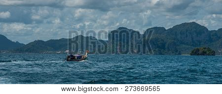Traditional Thai Boat On The Sea With Mailand In The Background