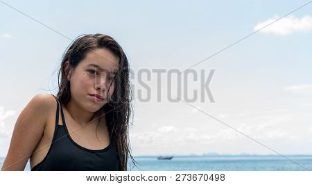 Close Up Of Teen Girl At The Beach Looking Into Camera