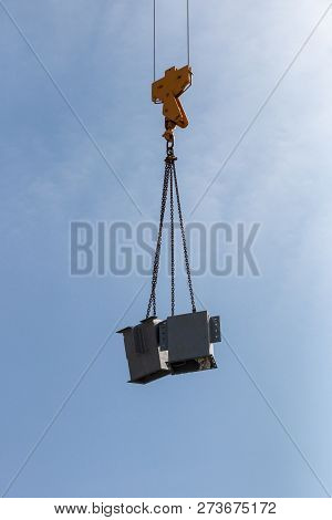 A Close Up View Of The Arm Of A Yellow Crane Liftting Up A Metal Stands On A Construction Site