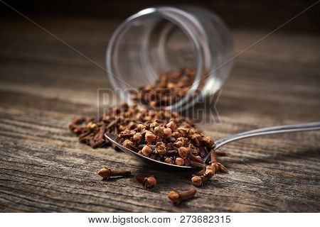 Dried Cloves  On A Gray Wooden Background