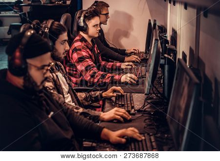 Team Of Teenage Gamers Plays In A Multiplayer Video Game On Pc In A Gaming Club.