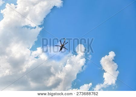 Helicopter Flies In The Blue Sky With With Clouds. Outdoor, Sunny Day, Bright Color, Copy Space.