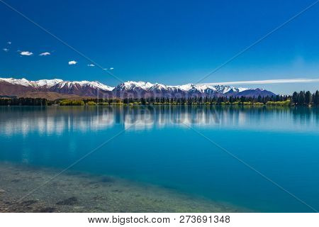 Lake Ruataniwha, New Zealand, South Island, trees and mountains, water reflections