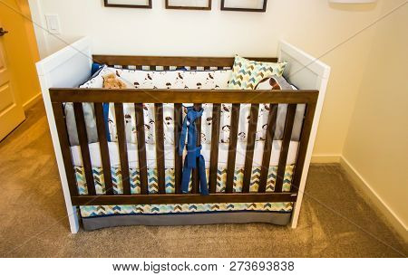 Bay Crib With Wooden Railings In Bedroom