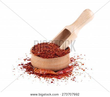 Dry And Crushed Chili Pepper Flakes Isolated On White Background. Red Chili Pepper In The Wooden Bow