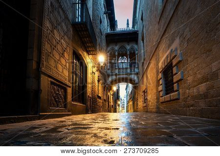 Barri Gothic Quarter And Bridge Of Sighs At Night In Barcelona, Catalonia, Spain.