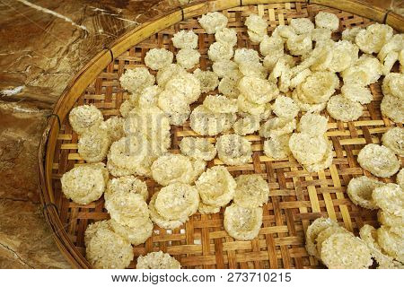 Flat Sticky Rice Cake Patties Drying Outdoors On A Woven Bamboo Tray In Luang Prabang, Laos