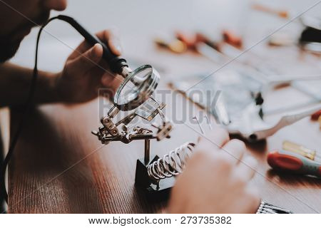 Close Up. Young Man Repairing Mobile Phone. Repair Shop. Worker With Tools. Magnifying Glass. Digita