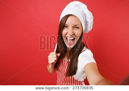 Housewife Female Chef Cook Or Baker In Striped Apron, White T-shirt, Toque Chefs Hat Isolated On Red
