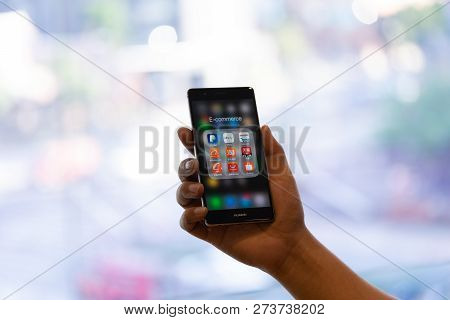 Chiang Mai, Thailand - Oct. 28,2018: Man Holding Huawei With Icons Of E-commerce And Online Shopping