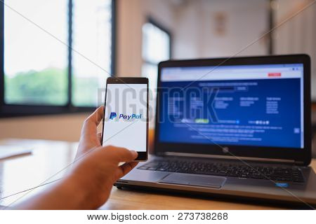 Chiang Mai, Thailand - June 03,2018: Man Holding Huawei With Paypal Apps On The Screen. Paypal Is An