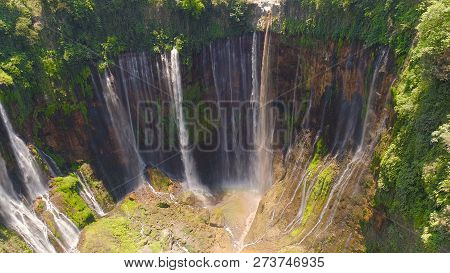Beautiful Waterfall Coban Sewu In Tropical Forest, Java Indonesia. Aerial View Tumpak Sewu Waterfall
