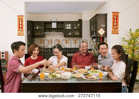 Parent, Grandparents And Children Enjoying Good Food At Lunar New Year Celebration, Couplets With Be
