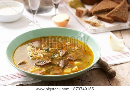 Rassolnik, Traditional Russian Soup, Served With Various Snacks And Vodka. Rustic Style.