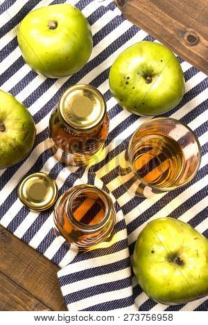 Home Made Apple Juice From An Old British Apple Variety, Bramley In A Glass And Bottle