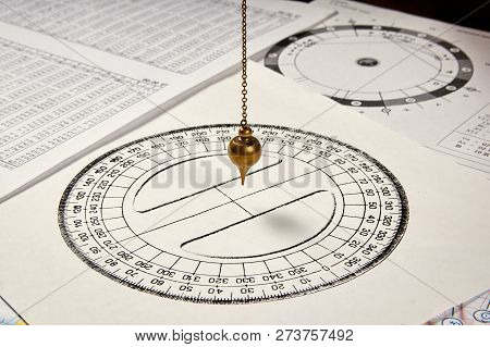 Astrological Pendulum For Tarot And Astrological Circle On The Background Of Astrological Sheets