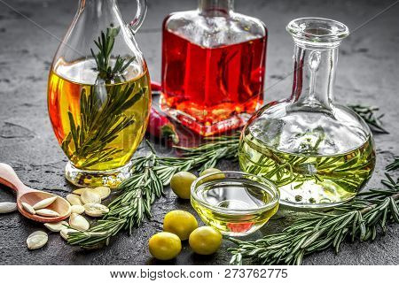 Oil In Carafe With Spices, Olives And Chili On Stone Background