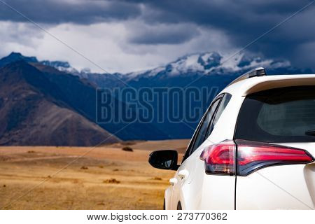 White car back view on mountanious Peru background