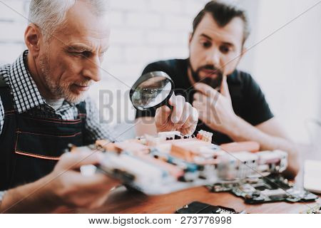 Two Men Repairing Hardware Equipment From Pc. Repair Shop. Worker With Tools. Computer Hardware. You
