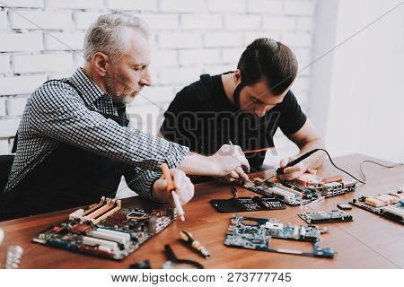 Two Men Repairing Hardware Equipment From Pc. Repair Shop. Worker With Tools. Computer Hardware. You