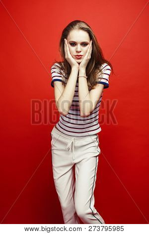 Young Pretty Teenage Girl On Bright Red Background, Happy Smilin