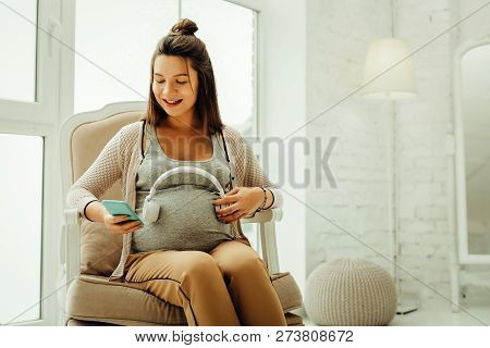 Pregnant Woman Communicating With Her Future Baby Using The Music