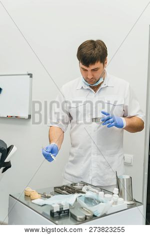 Doctor Used Microscope. Dentist Is Treating Patient In Modern Dental Office. Operation Is Carried Ou