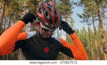 Training An Athlete On The Roller Skaters. Biathlon Ride On The Roller Skis With Ski Poles, In The H