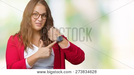 Beautiful plus size young business woman wearing elegant jacket and glasses over isolated background In hurry pointing to watch time, impatience, upset and angry for deadline delay