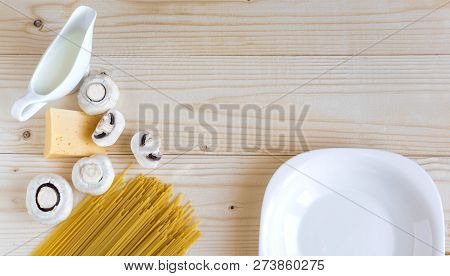 Wooden Background With Cheese, Spaghetti And Mushrooms. Cream. Background For Restaurants And Cafes.