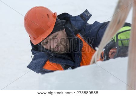 Worker Fitter In A Protective Helmet And Reflective Vest On The Working Meast