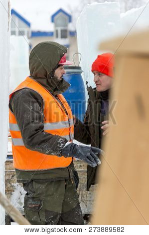Worker Fitter In A Protective Helmet And Reflective Vest On The Working Meast