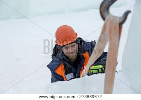 Worker Fitter In A Protective Helmet And Reflective Vest On The Working Meast