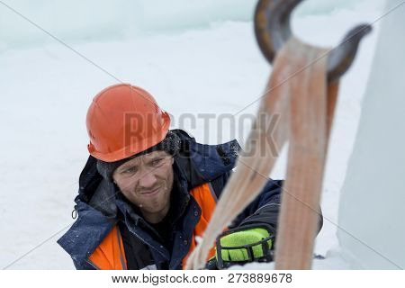 Worker Fitter In A Protective Helmet And Reflective Vest On The Working Meast