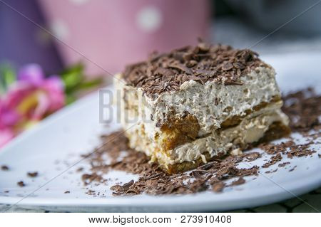 Tiramisu, Traditional Italian Dessert On A White Plate. Close Up.