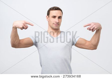 Italian Man In White T-shirt, Standing, Pointing Himself And Looking With Serious Egoist Face.