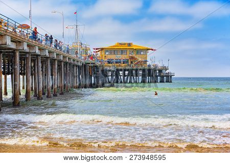Famous Pier In Santa Monica With Tourists, A Suburb Of Los Angeles.