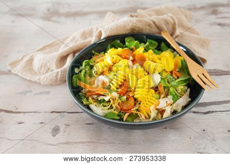 Salad made from radiatori cooked pasta, goat cheese and oil vinaigrette