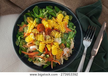 Salad made from radiatori cooked pasta, goat cheese and oil vinaigrette