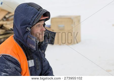 Worker Fitter In A Protective Helmet And Reflective Vest On The Working Meast