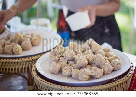 Vendor Preparing Dim Sum Chinese Dumplings At Shop.