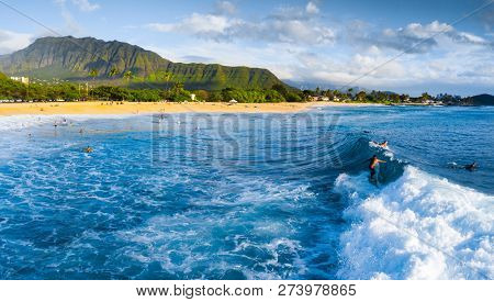 Panorama of the surf spot Makaha with the surfer riding the wave. Oahu, Hawaii