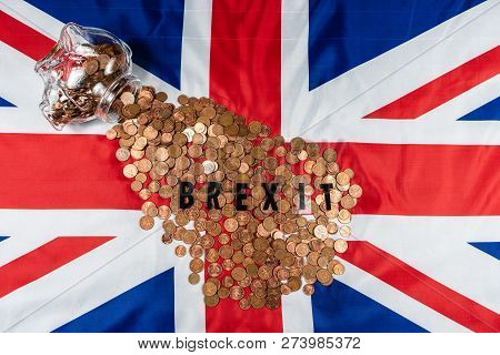 Brexit Concept Union Jack And Eu Flag Separated.piggy Coin Bank On Side,1p And 2p Coins.