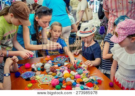 Zaporozhia/ukraine- June 2, 2018: Charity Family Festival-young Woman - Volunteer Explaining To Girl