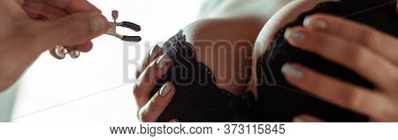 View Of Man Holding Nipple Clamp Near Big Breast, Panoramic Shot