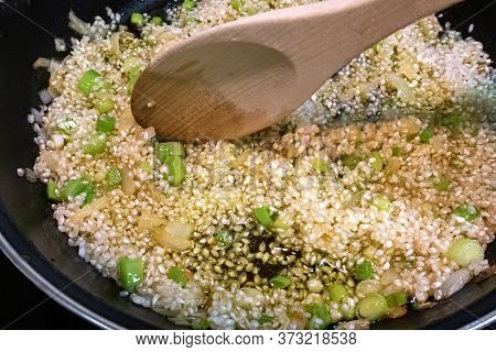 Rice Fried With Olive Oil With Garlic And Onion Wooden Spoon