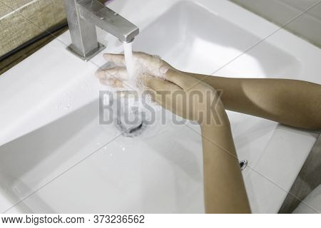 Close-up Of Washing Hands In The Sink To Prevent Germs. Hygiene Concept And Virus Prevention.