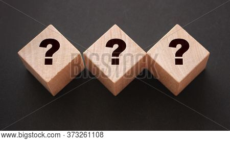 Three Wooden Blocks With Black Question Marks. Faq Questions And Answers Concept. Educaion Or Busine