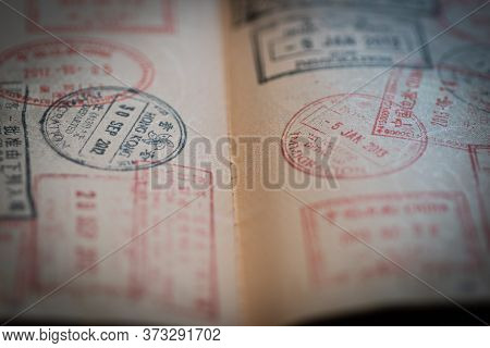 Closeup Of An Open Passport With Different Stamps